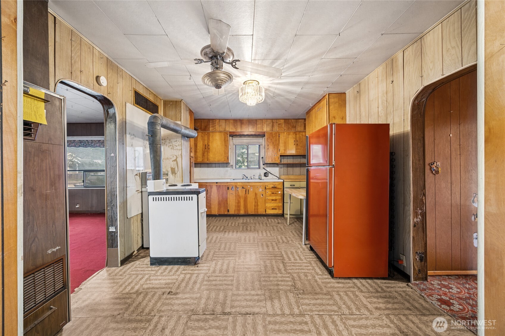 6931 South Tyler Street Tacoma, WA 98409 - Photo 4 of 20 a kitchen with a refrigerator a sink and cabinets