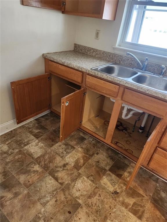 106 Larry Street Aliquippa, PA 15001 - Photo 6 of 14 a kitchen with granite countertop a sink and a stove