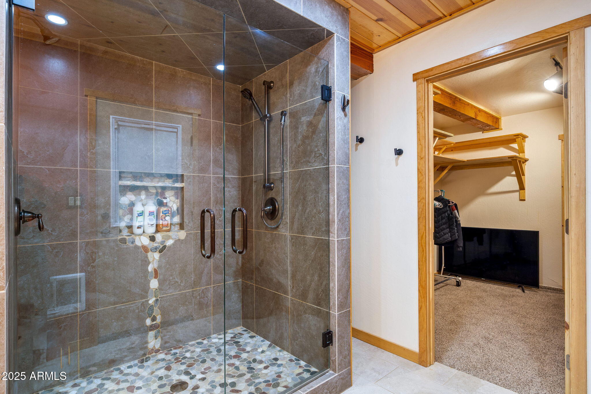 2444 South Jan Lane Pinetop, AZ 85935 - Photo 21 of 61 a bathroom with a glass door shower