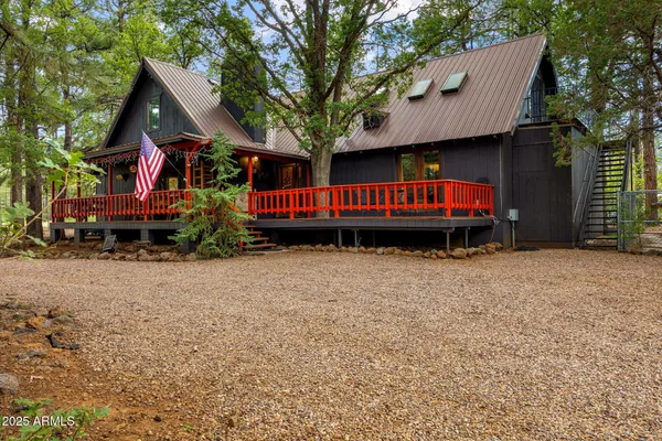 a view of a house with a yard and deck