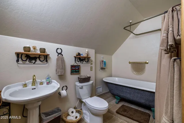 a bathroom with a sink toilet and mirror
