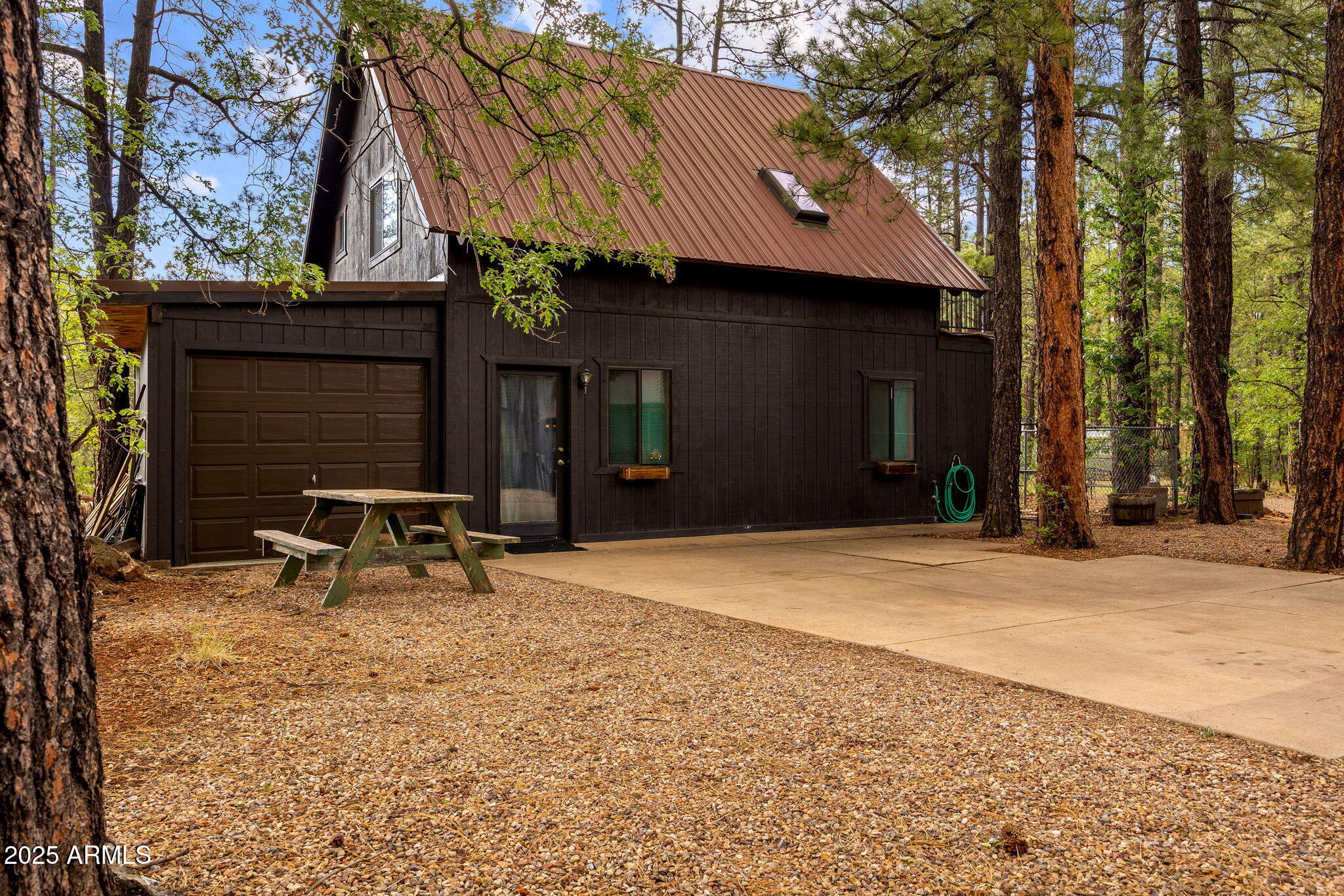 2444 South Jan Lane Pinetop, AZ 85935 - Photo 44 of 61 a view of a bench in front of a building