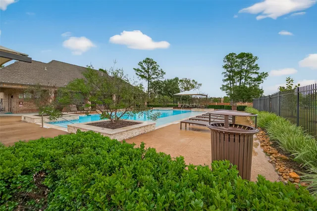 a view of a swimming pool with an outdoor seating and a yard