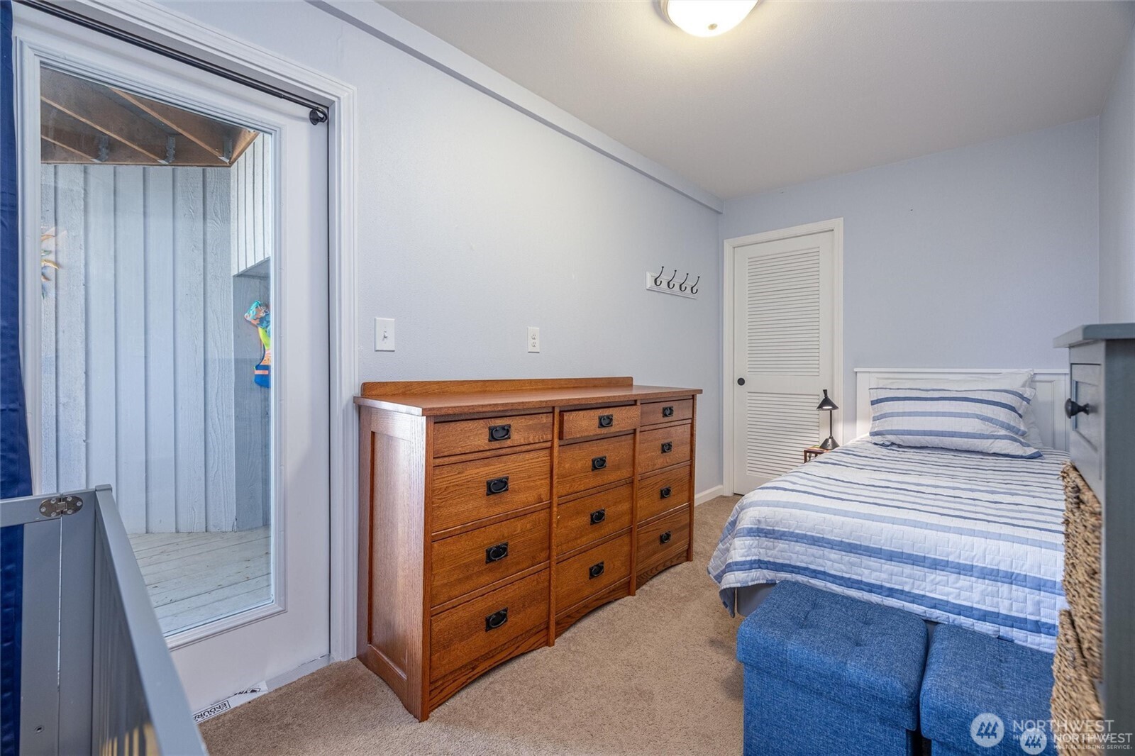 2877 North Nugent Road, Unit M4 Lummi Island, WA 98262 - Photo 23 of 31 a bedroom with a bed and a dresser