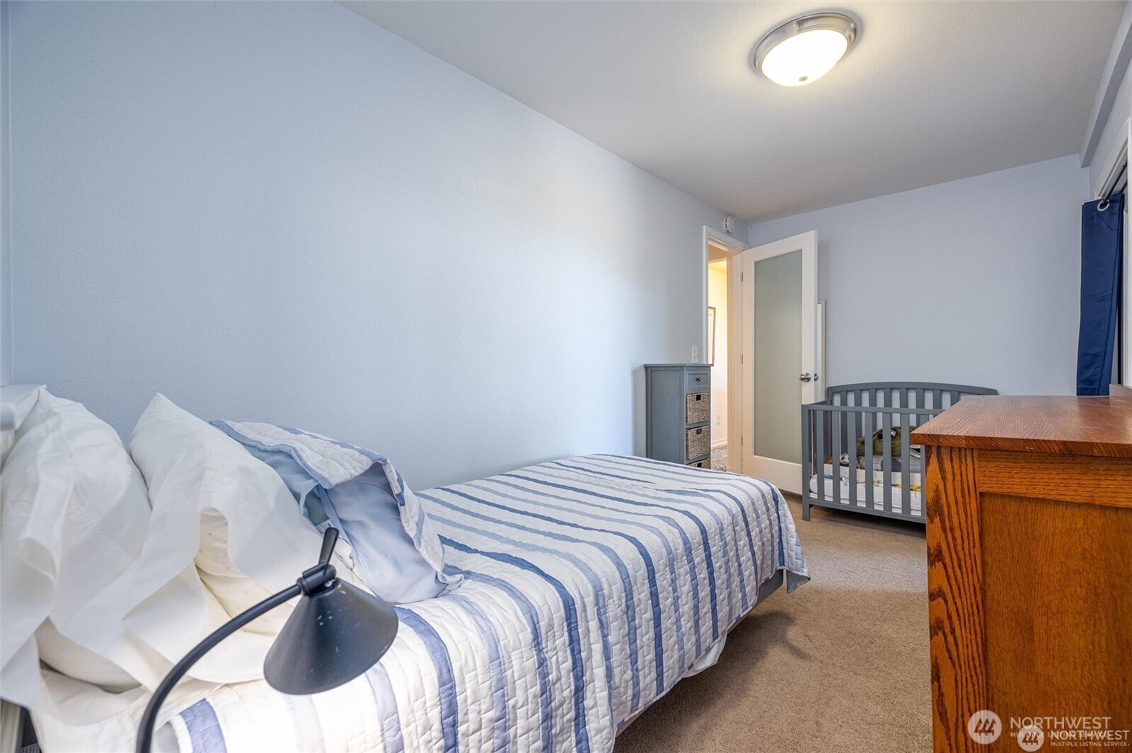 2877 North Nugent Road, Unit M4 Lummi Island, WA 98262 - Photo 24 of 31 a bedroom with a bed and a dresser