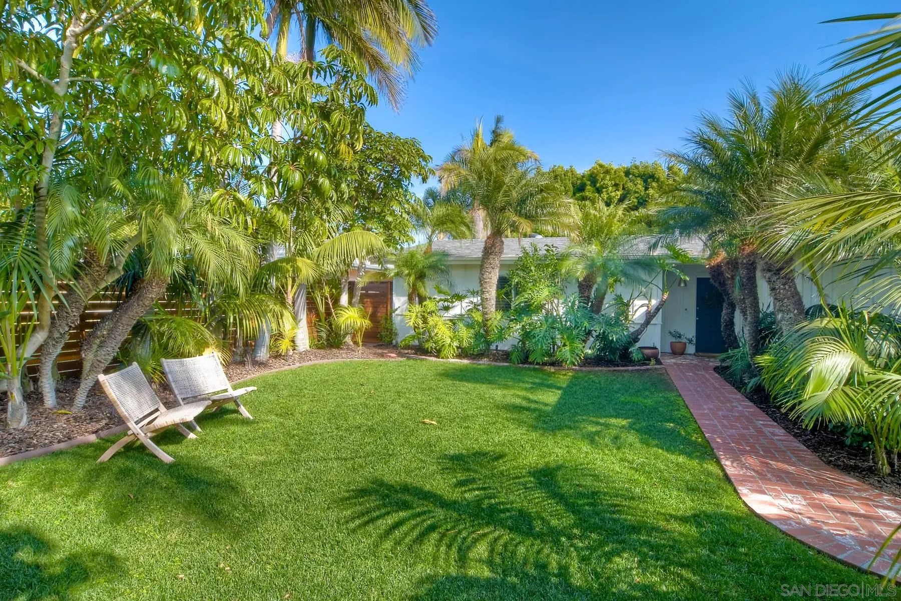 a view of a backyard with sitting area
