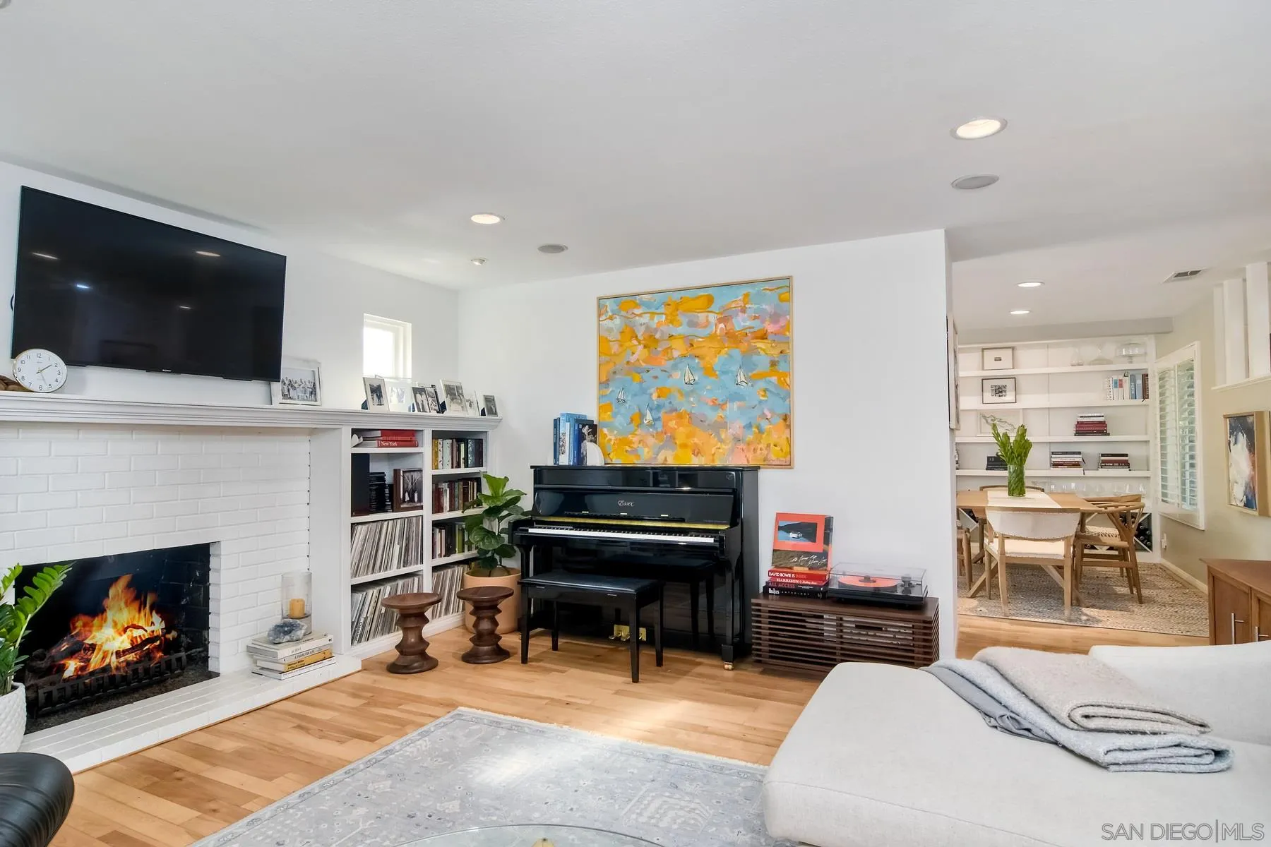 1161 Balour Drive Encinitas, CA 92024 - Photo 18 of 26 a living room with furniture a flat screen tv and a fireplace