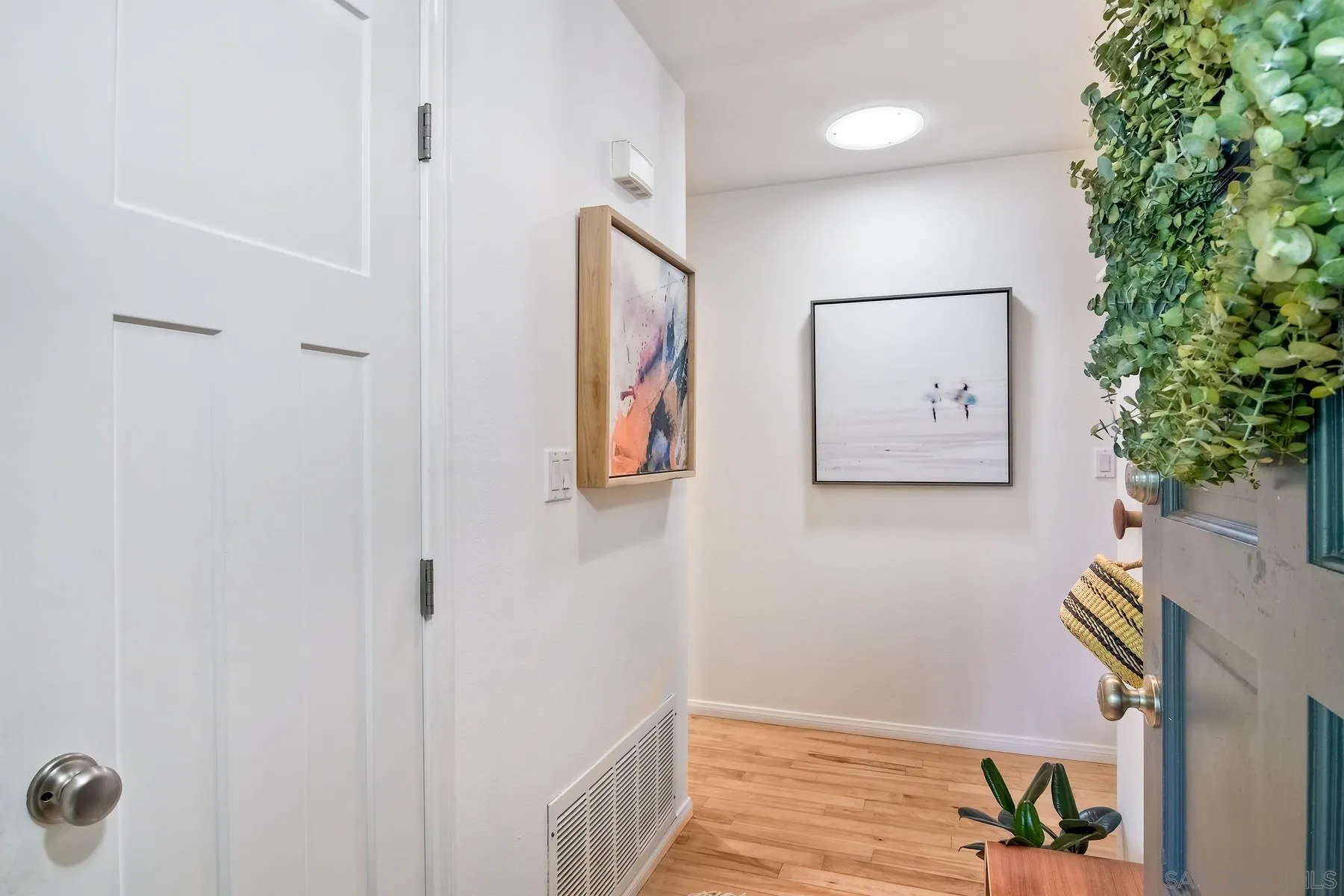 1161 Balour Drive Encinitas, CA 92024 - Photo 20 of 26 a view of a hallway with paintings on the wall