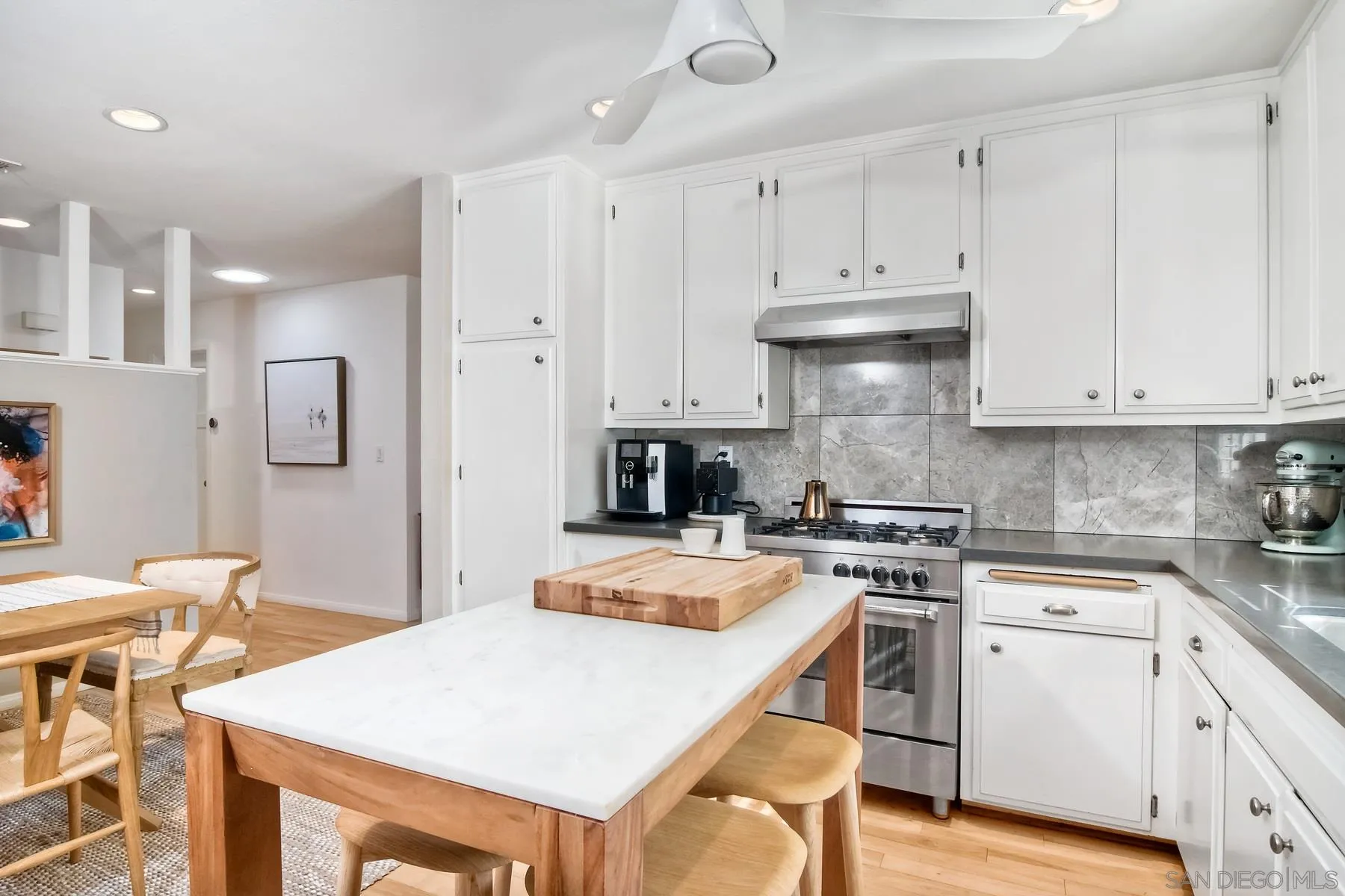 1161 Balour Drive Encinitas, CA 92024 - Photo 5 of 26 a kitchen with granite countertop white cabinets and white appliances