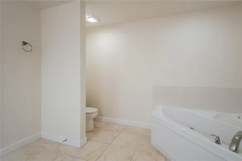 a spacious bathroom with a double vanity sink and a mirror
