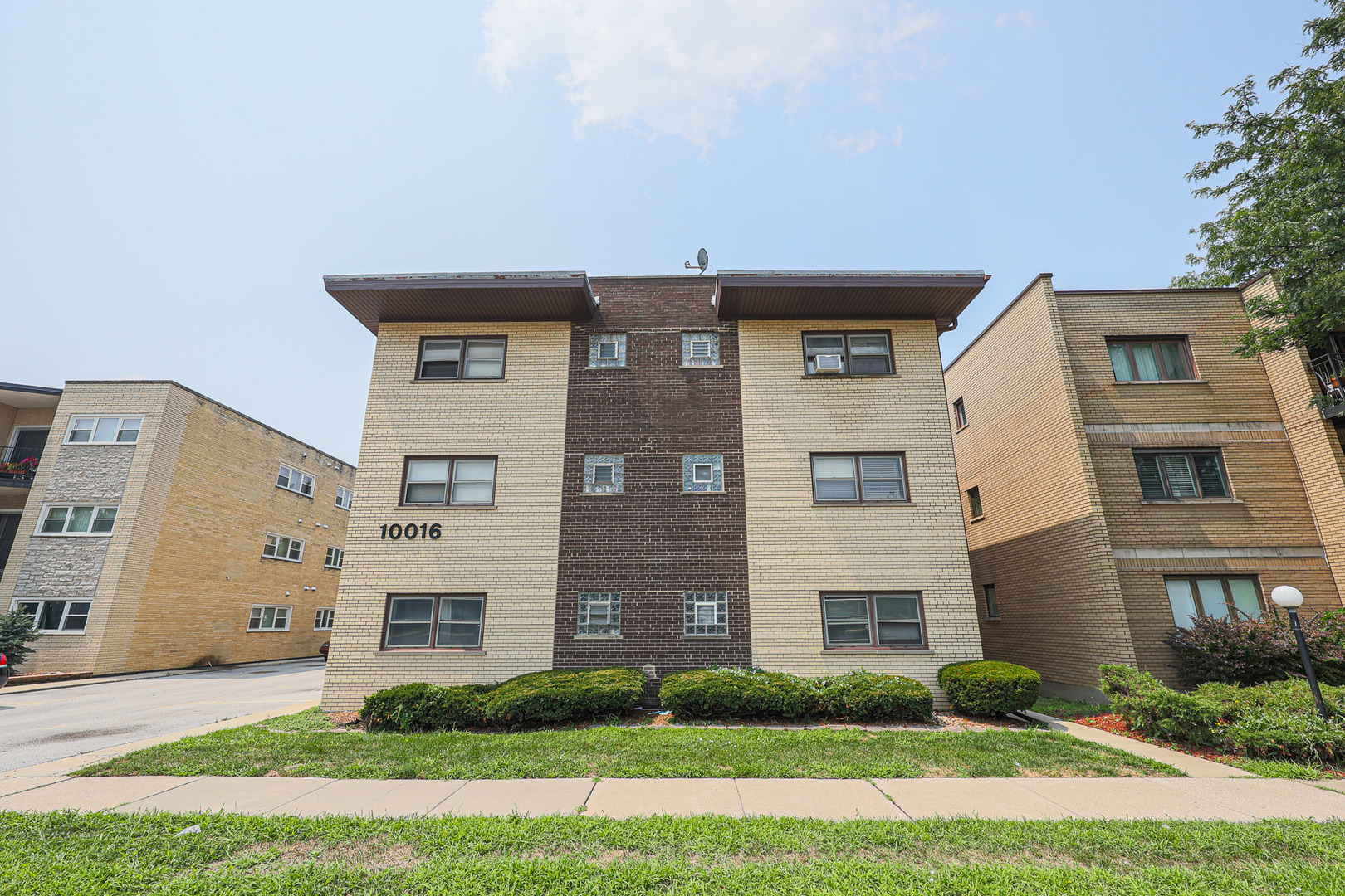 10016 South Pulaski Road, Unit 3 Oak Lawn, IL 60453 - Photo 1 of 39 a front view of a house with garden
