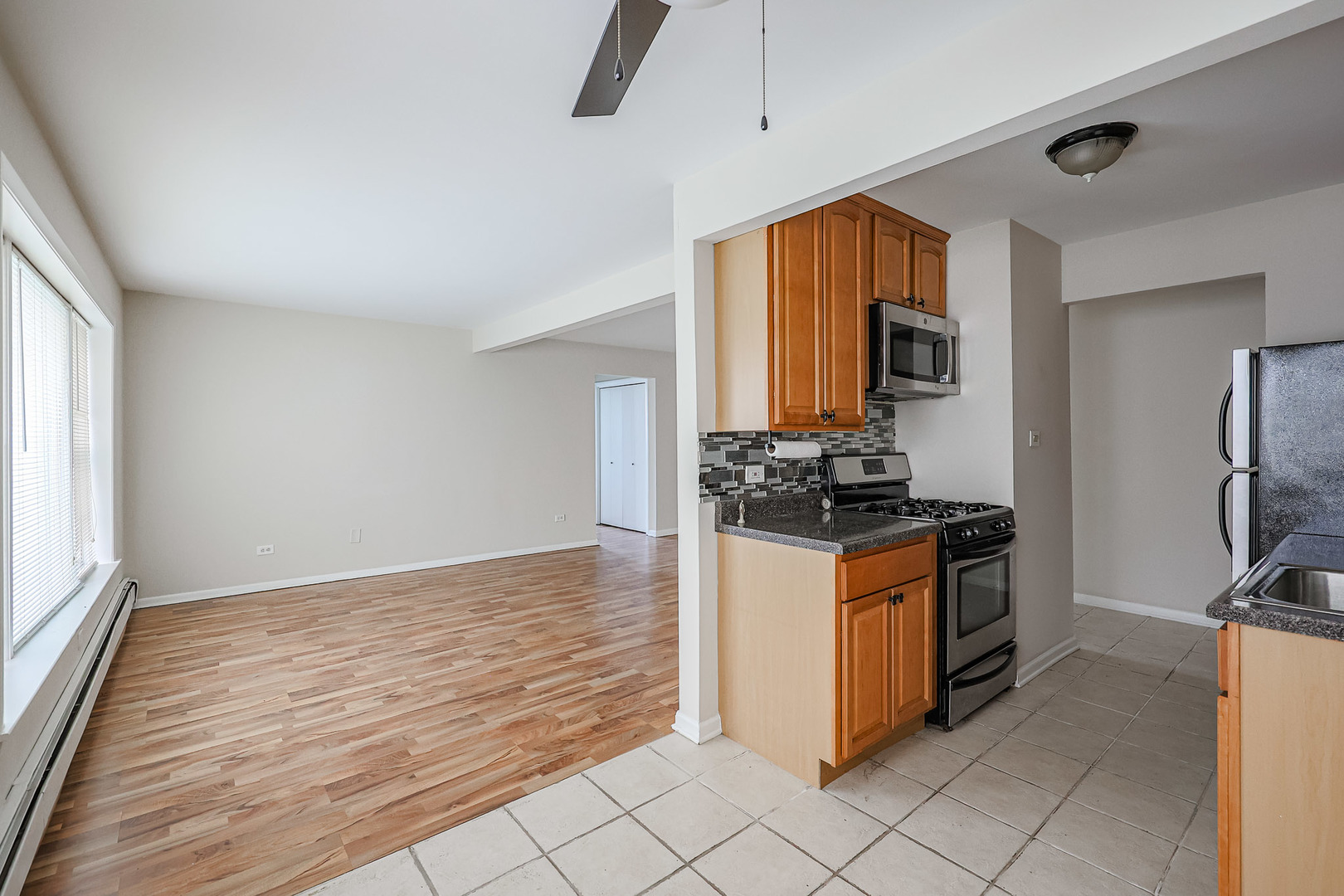 10016 South Pulaski Road, Unit 3 Oak Lawn, IL 60453 - Photo 16 of 39 a kitchen with stainless steel appliances granite countertop a stove a refrigerator and a sink