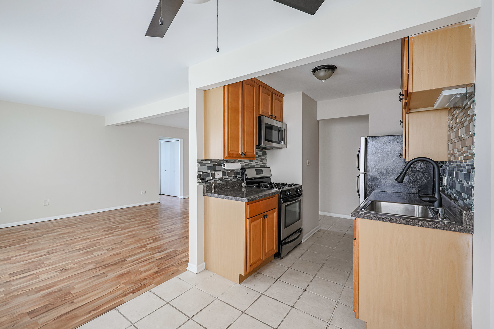 10016 South Pulaski Road, Unit 3 Oak Lawn, IL 60453 - Photo 17 of 39 a kitchen with stainless steel appliances granite countertop a sink and a refrigerator