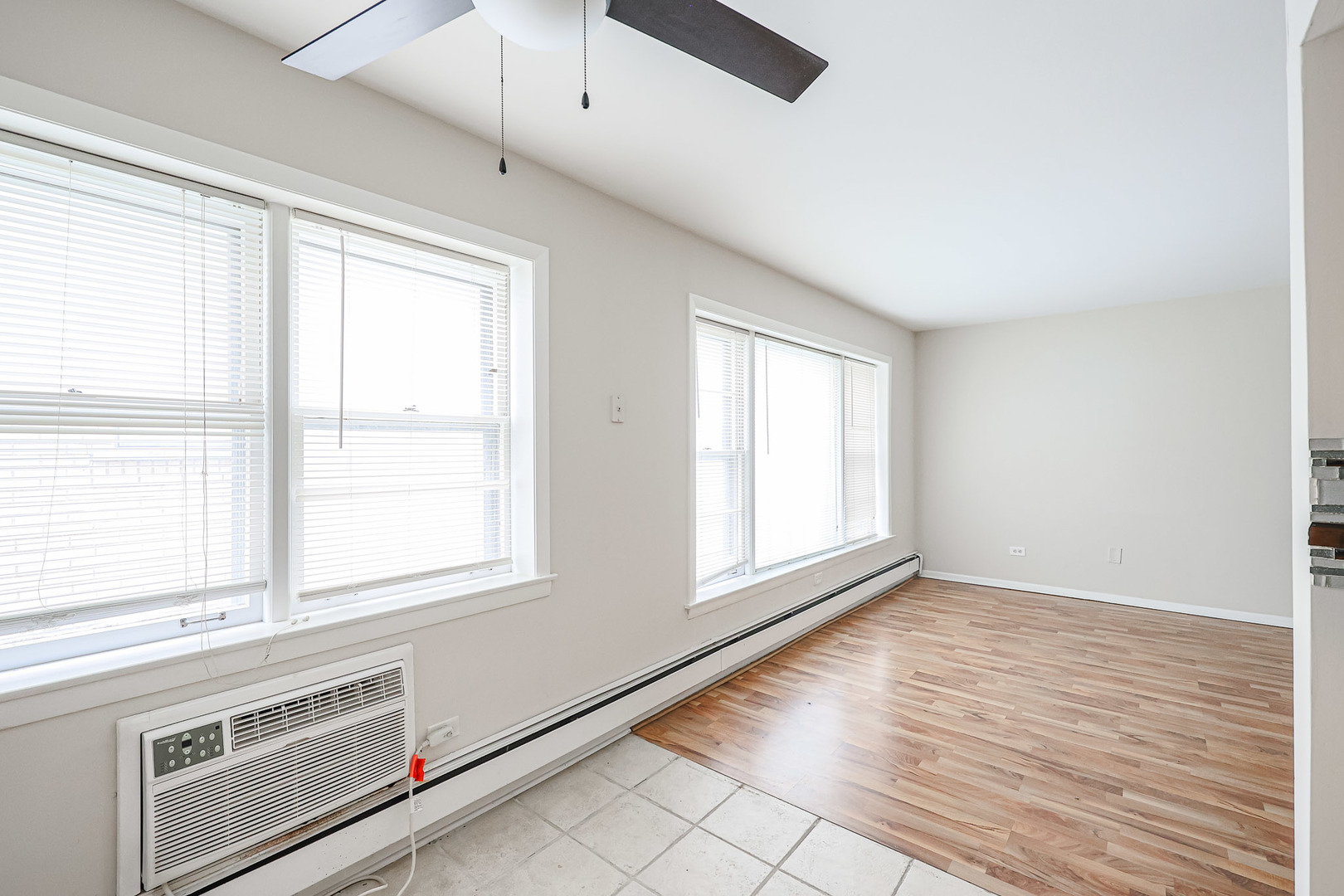 10016 South Pulaski Road, Unit 3 Oak Lawn, IL 60453 - Photo 18 of 39 a view of an empty room with a window and wooden floor