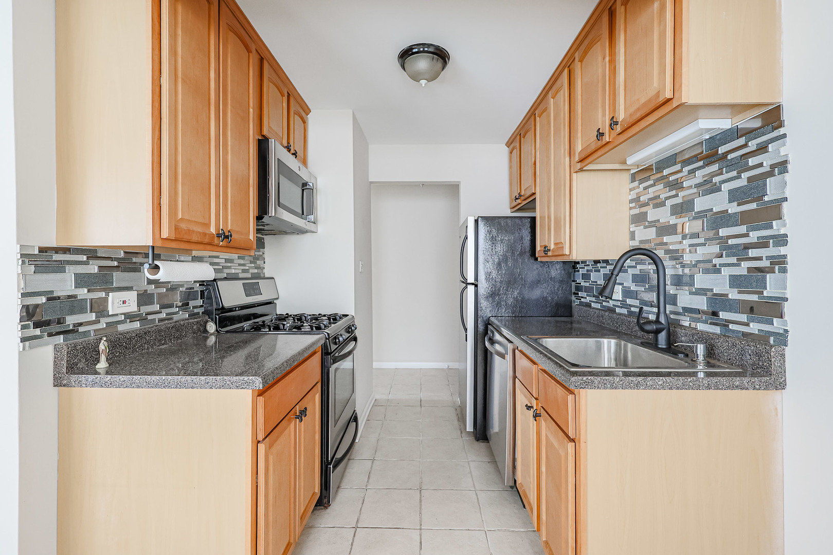 10016 South Pulaski Road, Unit 3 Oak Lawn, IL 60453 - Photo 19 of 39 a kitchen with stainless steel appliances granite countertop a sink and a stove