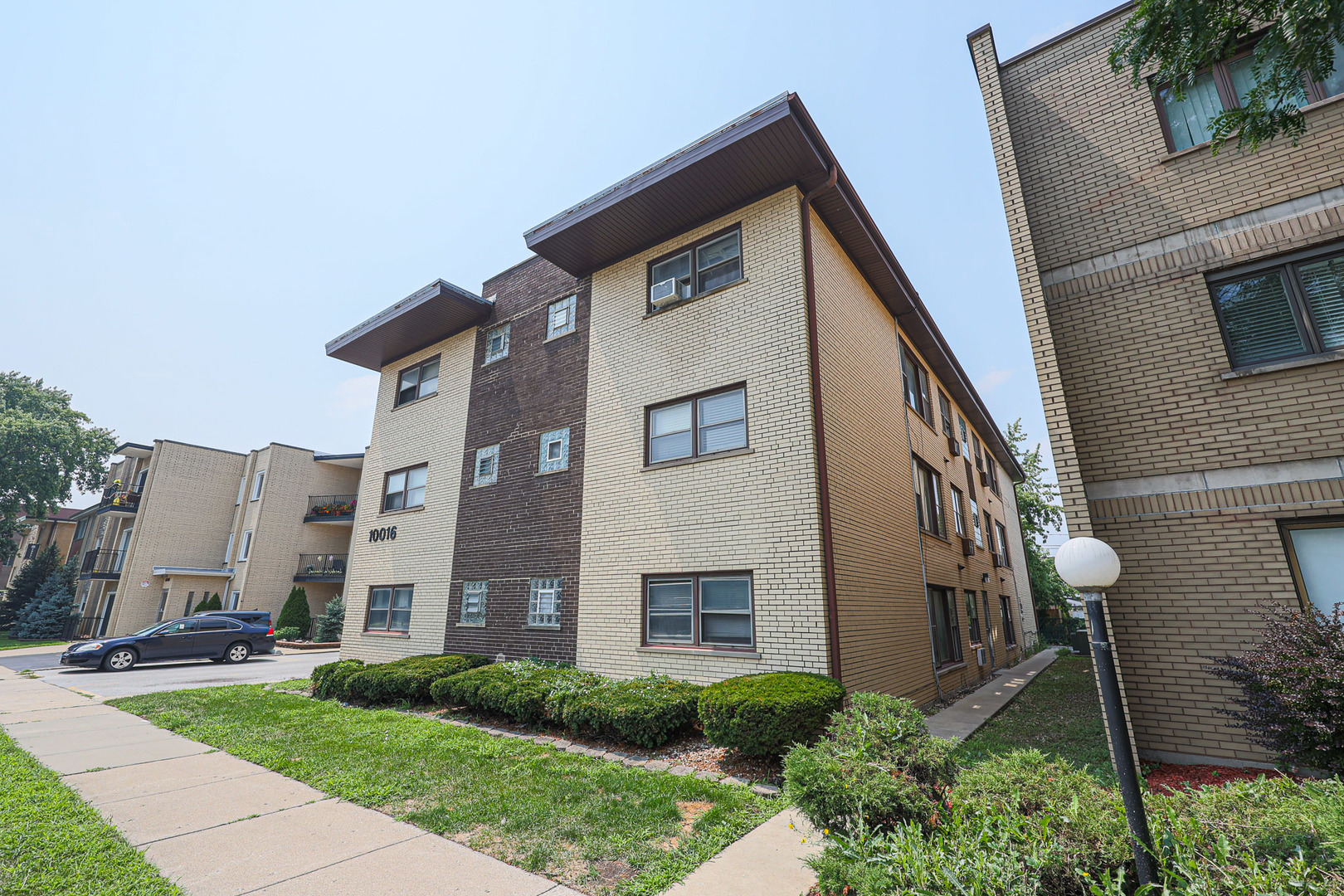 10016 South Pulaski Road, Unit 3 Oak Lawn, IL 60453 - Photo 2 of 39 a front view of a house with a yard