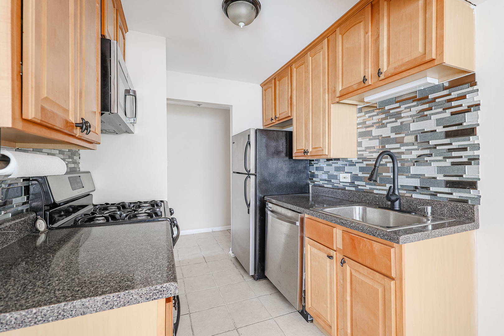 10016 South Pulaski Road, Unit 3 Oak Lawn, IL 60453 - Photo 21 of 39 a kitchen with stainless steel appliances granite countertop a sink stove and refrigerator