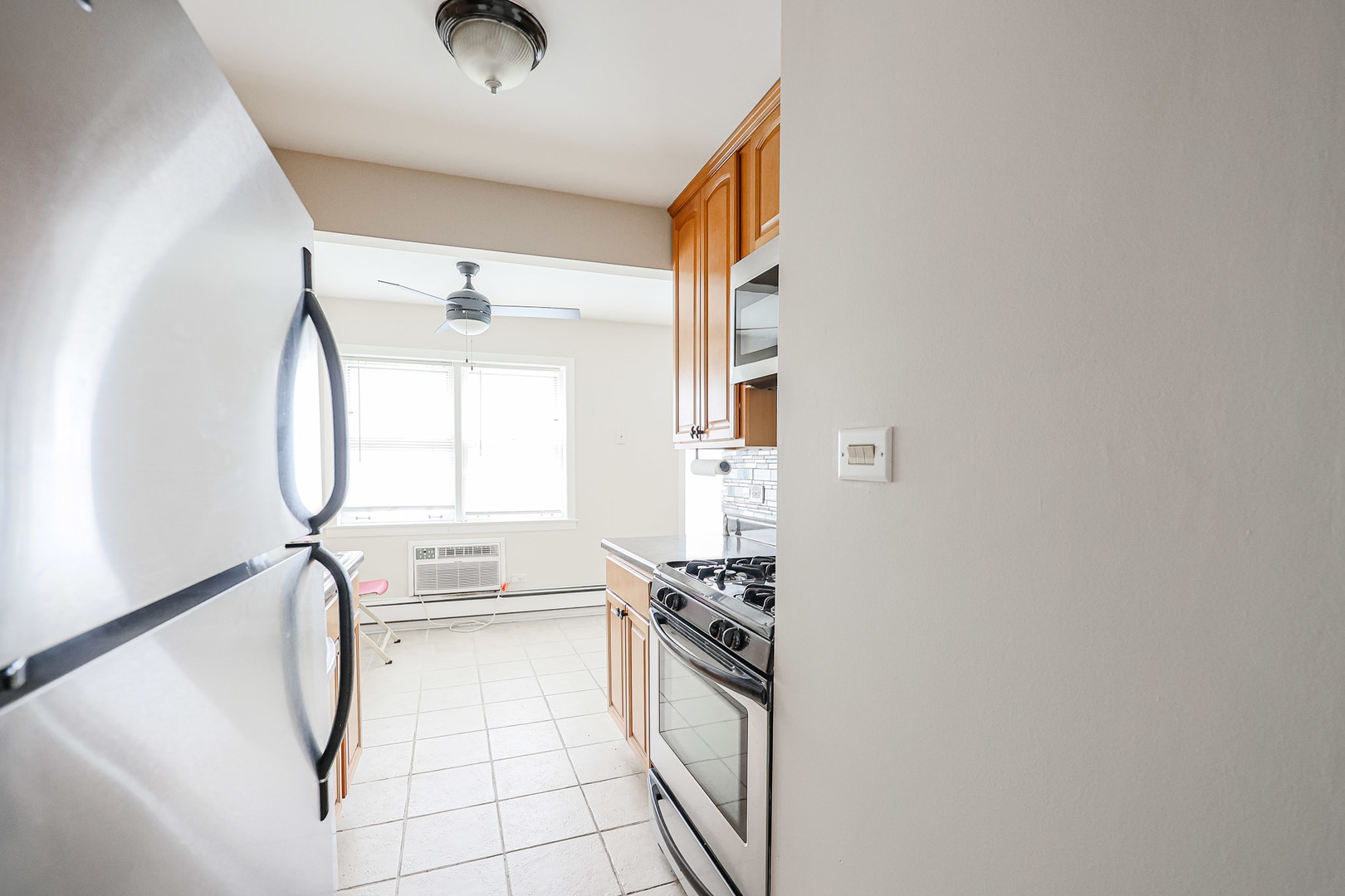 10016 South Pulaski Road, Unit 3 Oak Lawn, IL 60453 - Photo 24 of 39 a kitchen with granite countertop a stove a sink and a refrigerator with wooden floor