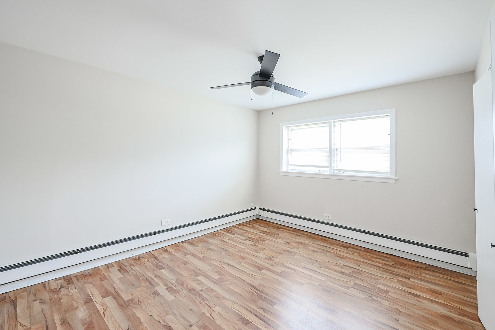 10016 South Pulaski Road, Unit 3 Oak Lawn, IL 60453 - Photo 28 of 39 a view of an empty room with wooden floor and a window