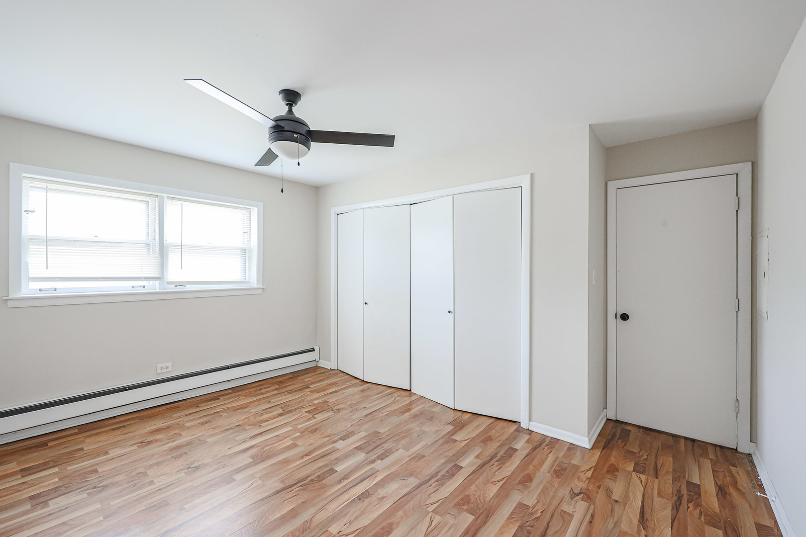10016 South Pulaski Road, Unit 3 Oak Lawn, IL 60453 - Photo 29 of 39 a view of an empty room with wooden floor and a window
