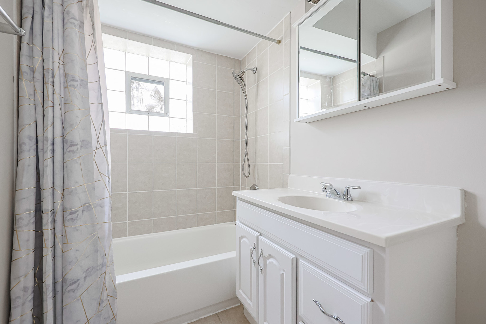10016 South Pulaski Road, Unit 3 Oak Lawn, IL 60453 - Photo 31 of 39 a bathroom with a sink a mirror and a bathtub