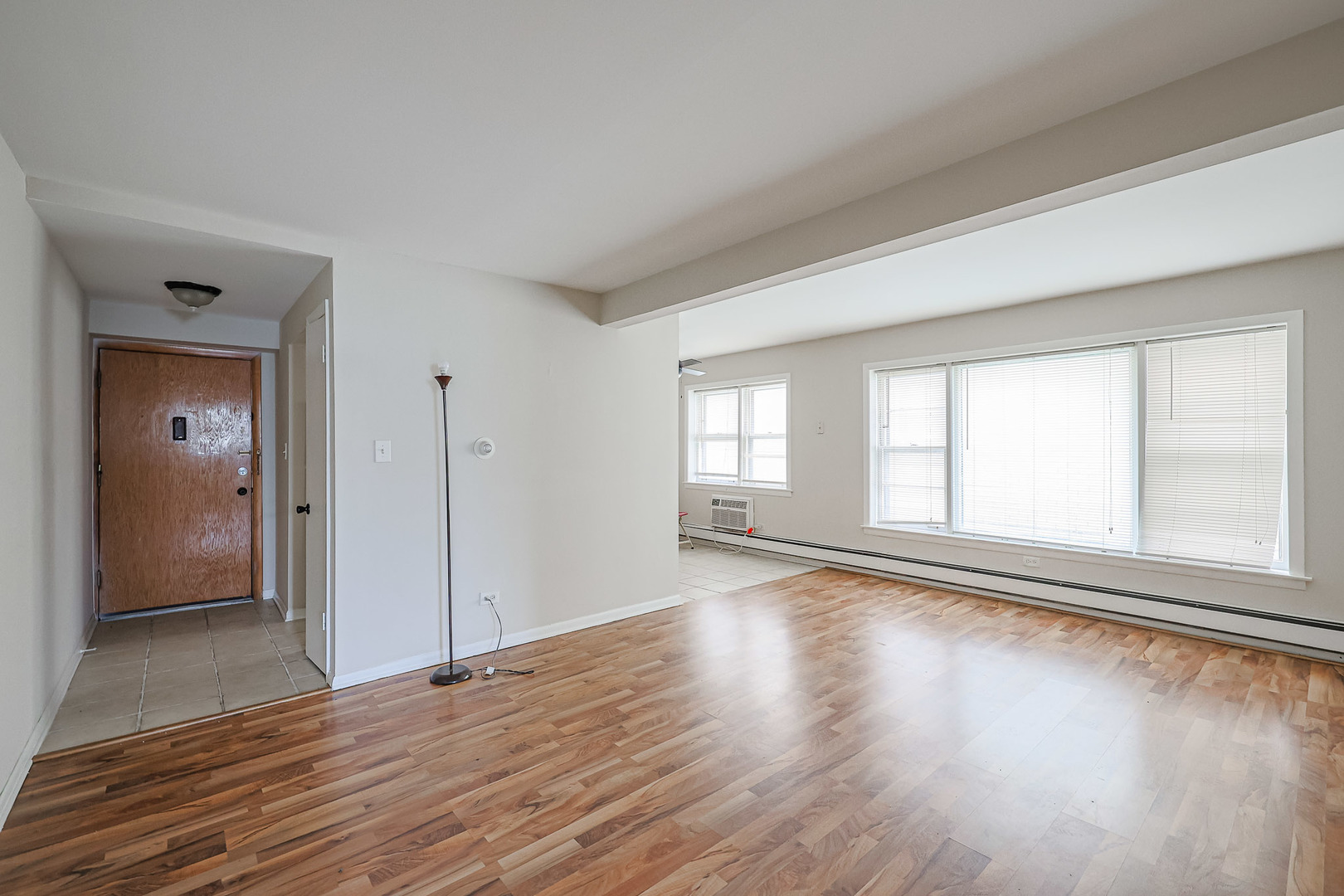 10016 South Pulaski Road, Unit 3 Oak Lawn, IL 60453 - Photo 10 of 39 a view of an empty room with wooden floor and a window