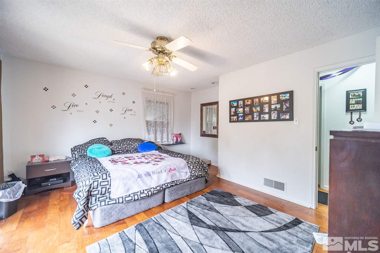 960 Keystone Avenue Reno, NV 89503 - Photo 23 of 40 a bedroom with a bed and a chandelier