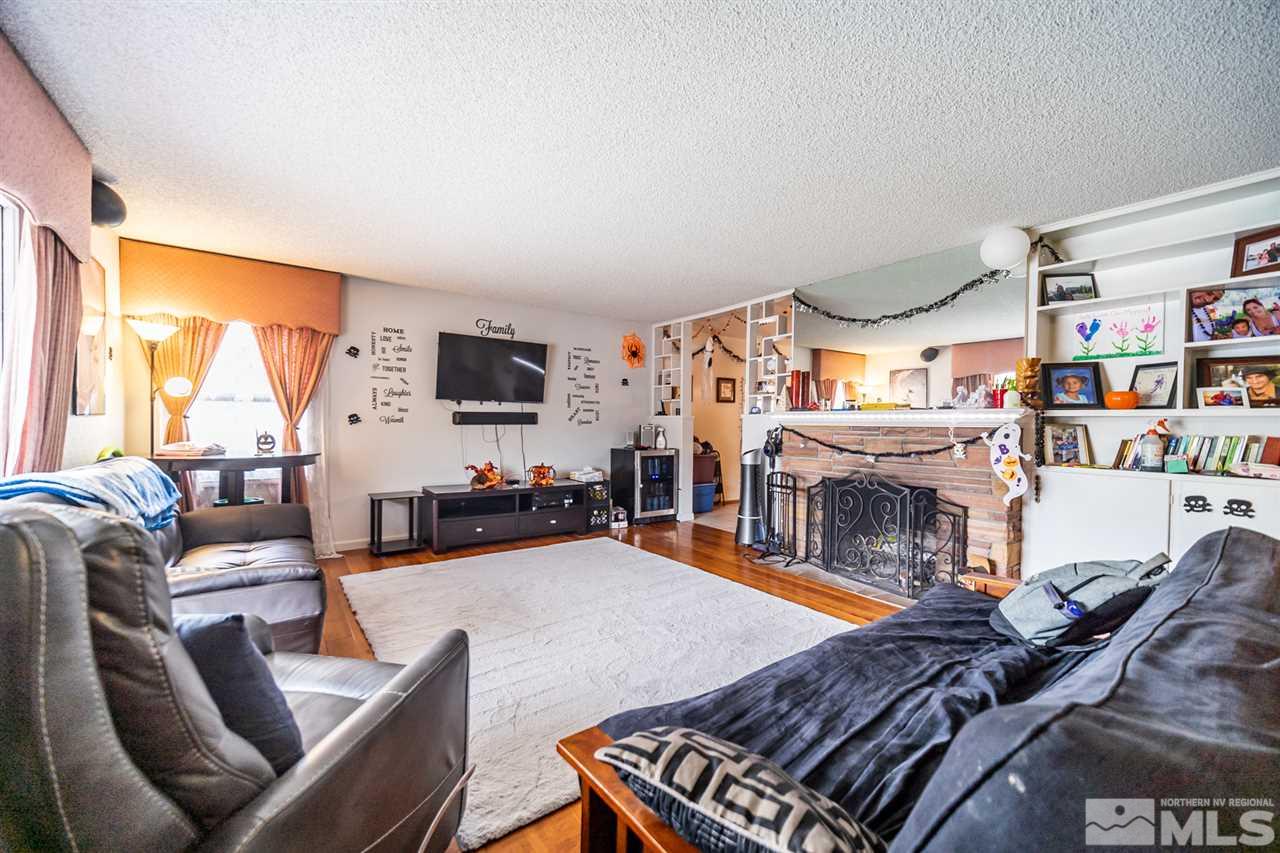 960 Keystone Avenue Reno, NV 89503 - Photo 6 of 40 a living room with furniture a flat screen tv and a fireplace