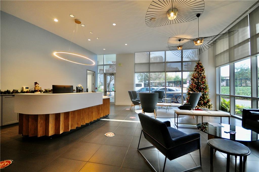 603 Davis Street, Unit 712 Austin, TX 78701 - Photo 15 of 22 a living room with furniture a rug and a chandelier
