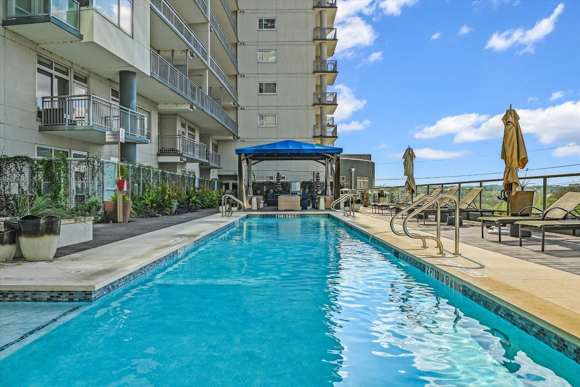 603 Davis Street, Unit 712 Austin, TX 78701 - Photo 17 of 22 a swimming pool with outdoor seating and yard