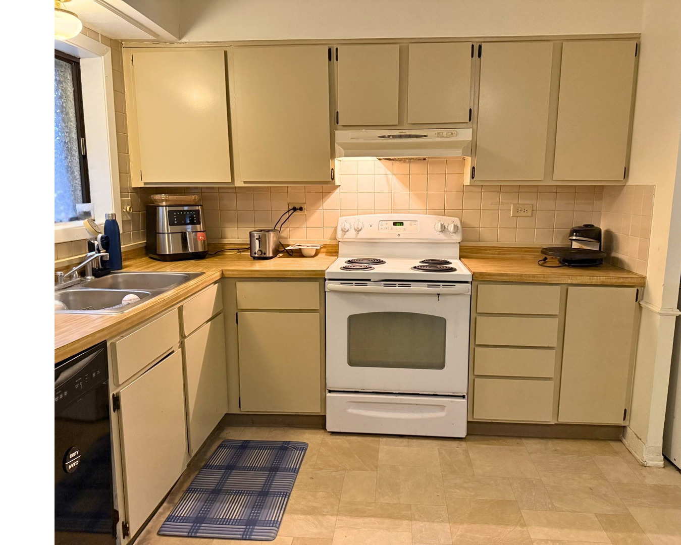 942 North Rohlwing Road, Unit GF Addison, IL 60101 - Photo 5 of 8 a kitchen with a stove top oven sink and cabinets