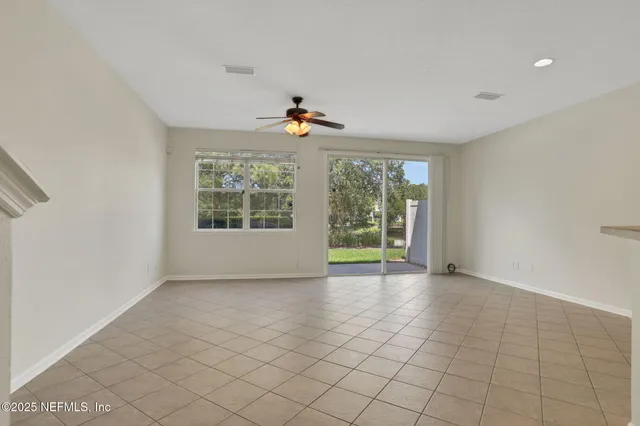a view of an empty room with a ceiling fan
