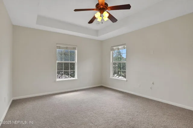 a view of a backyard with large trees