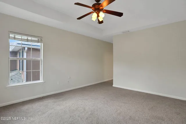 a view of an empty room and a walk in closet