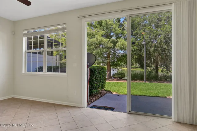 a view of a swimming pool with a chairs and table in the patio