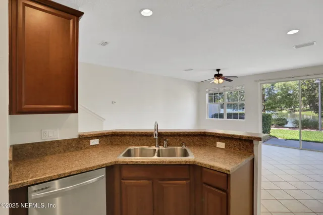 a metallic refrigerator freezer and a stove sitting inside of a kitchen