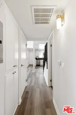 a view of a hallway with wooden floor