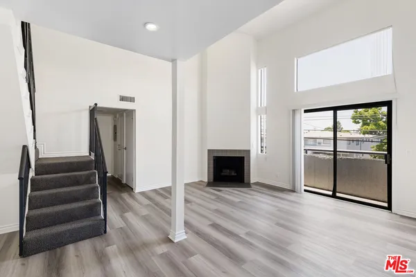 wooden floor in an empty room with a fireplace