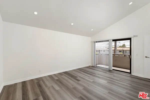 a view of wooden floor and windows in a room