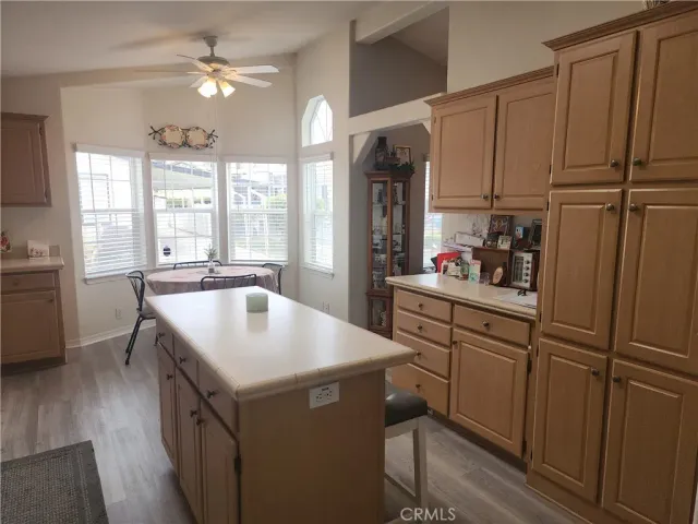 a kitchen with kitchen island a sink appliances cabinets and furniture