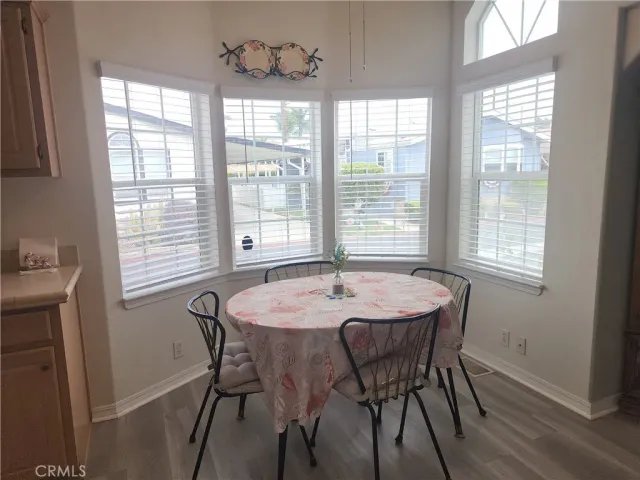 a dining room with wooden floor and breakfast area