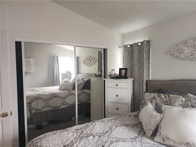 a bedroom with a bed and a mirror