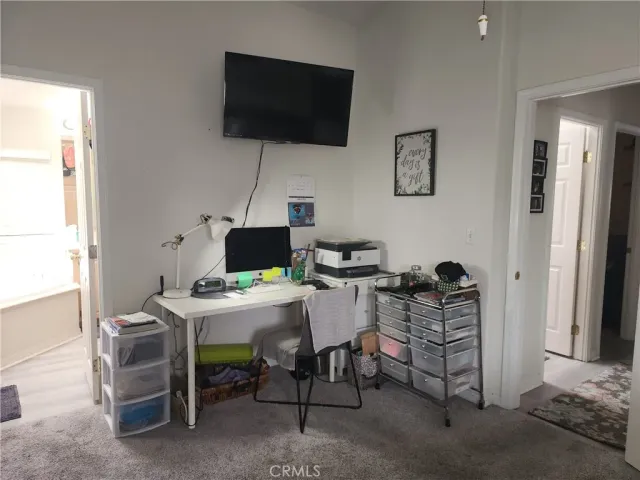 a work room with furniture and a flat screen tv