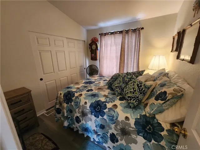 a bed sitting in a bedroom next to a window