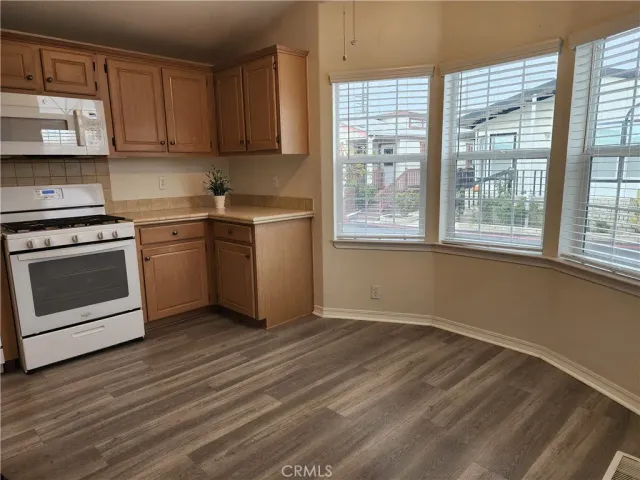 a kitchen with a stove a sink and a window