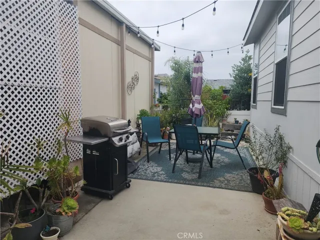 a view of a patio with table and chairs and potted plants