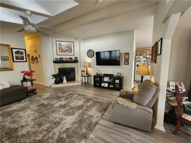 a living room with furniture a flat screen tv and a fireplace