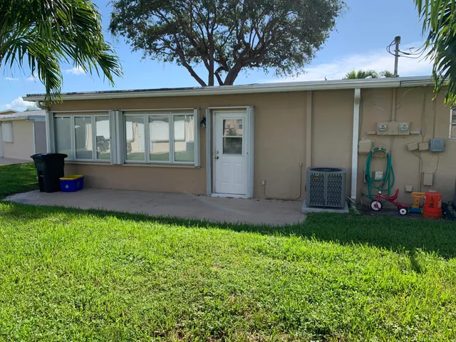 a front view of house with yard and outdoor seating