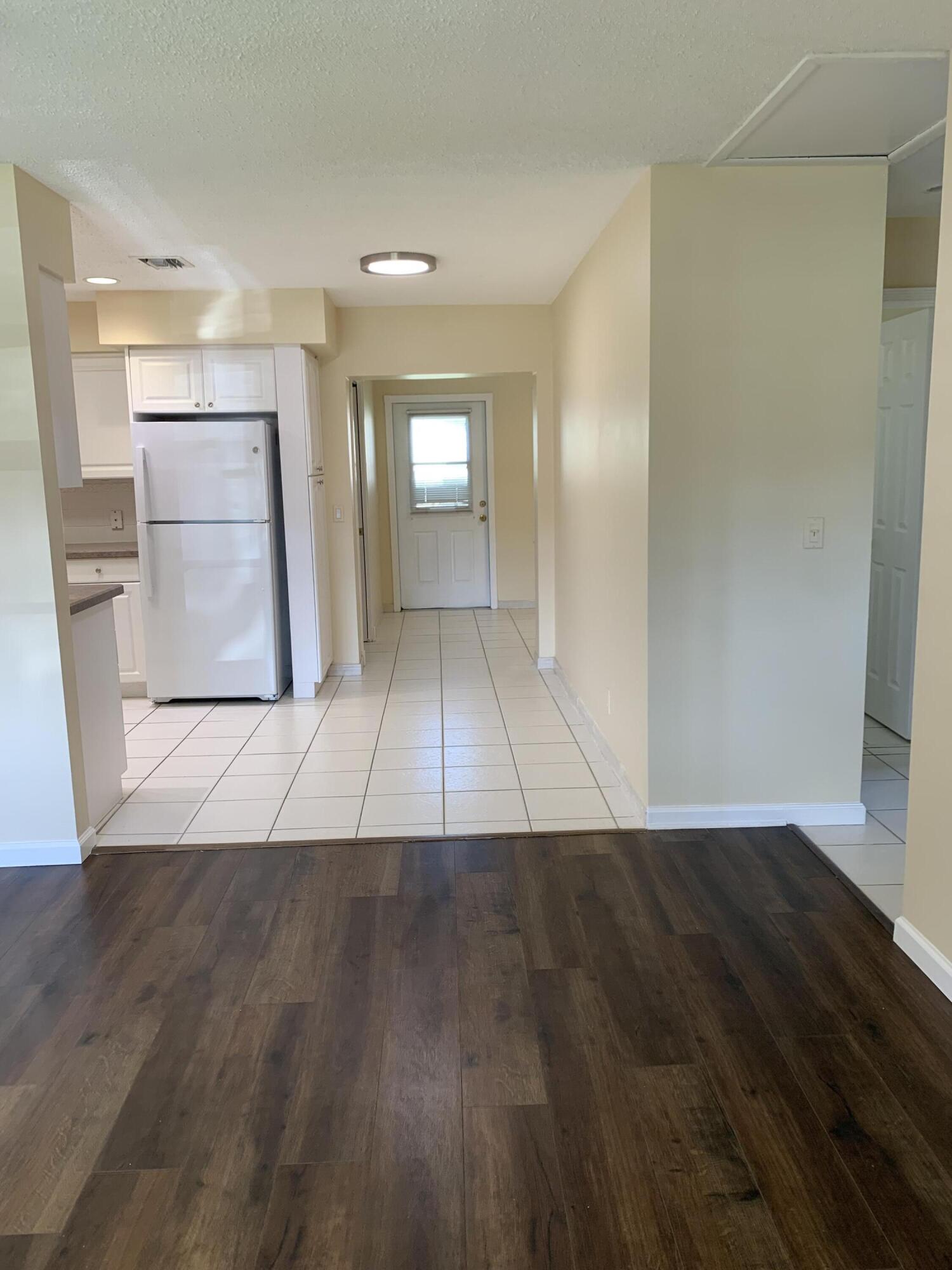2822 Duke Lane Delray Beach, FL 33445 - Photo 2 of 12 an entryway with wooden floor