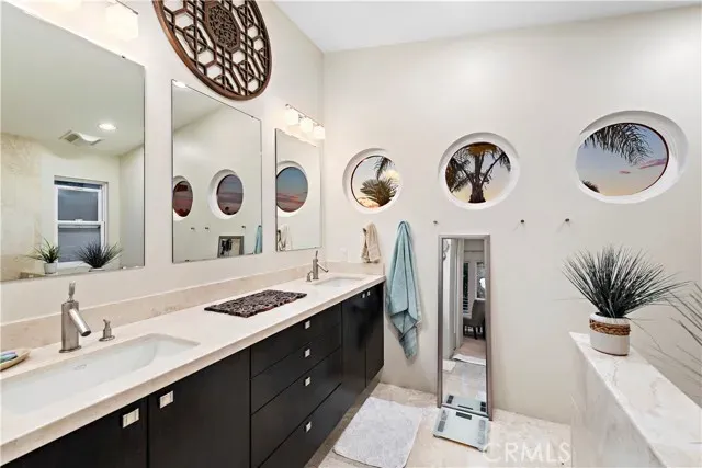 a living room with furniture a chandelier and a large window